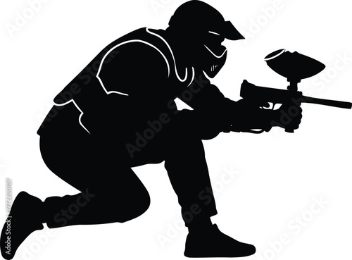Black silhouette of a paintball player in protective gear crouching with a marker gun ready to shoot