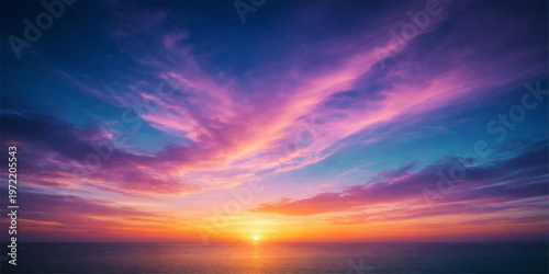Beautiful sunset over the sea and ocean with colorful clouds and warm evening light in the sky