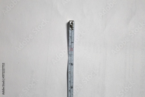 Fotografie Minimal centered tape measure on white background symbolizing measurement, scale, and precision