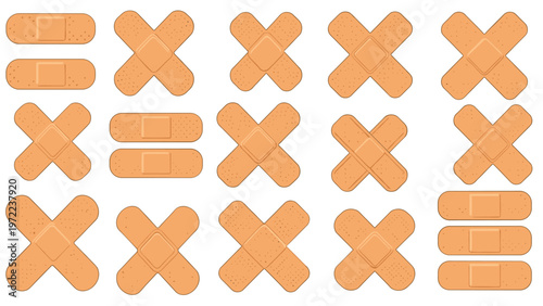Assortment of medical adhesive bandages in different shapes including strips and crosses for wound care and first aid.