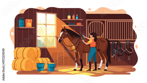 Young woman carefully grooming a brown horse inside a sunlit wooden stable with hay bales and riding equipment in the background.