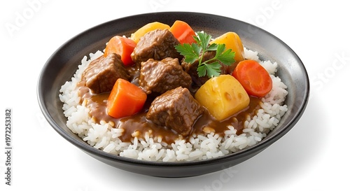 Delicious beef stew with vegetables served over white rice on plate