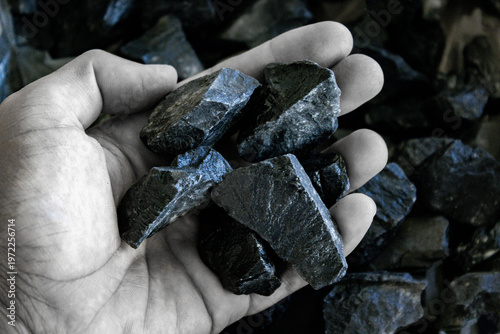 A photograph of coal lumps and natural energy. Clean energy. Global resources.