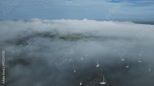 Calm morning fog over anchored boats in Kerikeri Inlet Bay of Islands New Zealand
