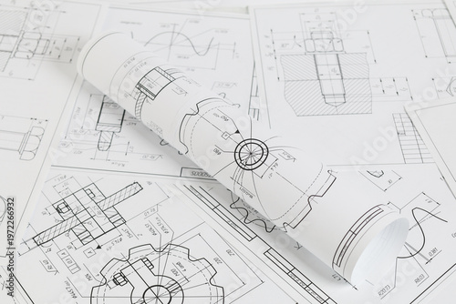 paper engineering drawings of industrial parts and mechanisms
