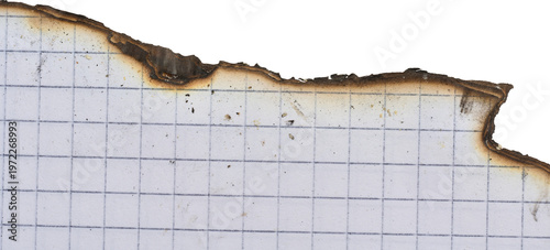 Sheet of white squared notebook paper with a badly burnt top edge and traces of dark soot