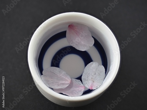 Tokyo, Japan - April 1, 2026: Closeup of Sakura cherry blossom petals in Sake cup

