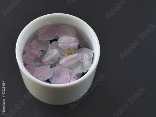 Tokyo, Japan - April 1, 2026: Closeup of Sakura cherry blossom petals in Sake cup

