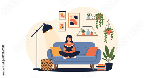 Young woman sitting cross-legged on a blue sofa and reading a book in a beautifully decorated cozy living room.