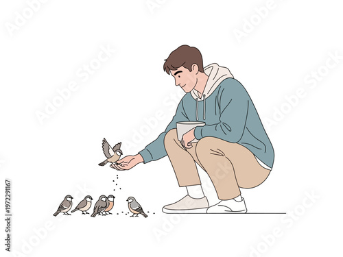 Young man feeding small birds from his hand.