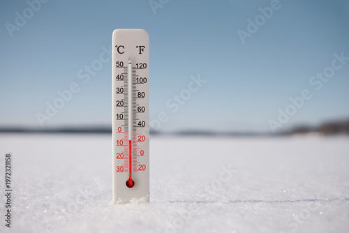 Celsius and fahrenheit scale thermometer in snow. Ambient temperature minus 6 degrees celsius