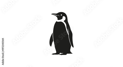A striking silhouette of an emperor penguin standing tall and proud.