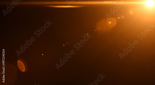 Warm orange light shining through a dark space with lens flares and a bright sunbeam in the corner
