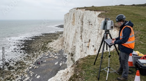 A coastal erosion researcher measures a cliff face retreat with a terrestrial laser scanner, the instrument mounted on a tripod at the cliff edge emitting an invisible point cloud