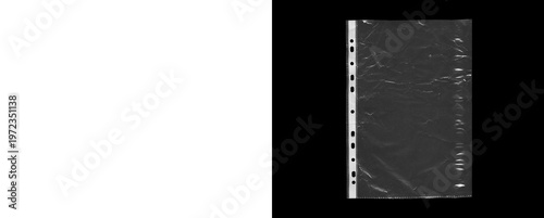 Fotografie Clear plastic page protector with punched holes and textured surface