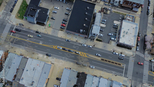 Marked intersection flow at Oregon Ave and S 10th St captures multi lane traffic patterns framed by mixed residential, commercial edges. Painted lanes, asphalt texture, crisp sunlight, Philly, PA