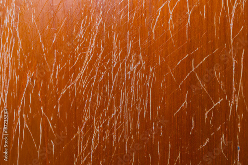 Macro top-down view of a heavily scratched and distressed wooden panel showing severe surface wear and evoking aging and neglect.