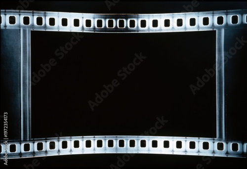 Vintage Film Strip Frame with Perforations on Black Background.