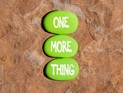 One more thing words symbol. Concept words One more thing on beautiful green stones. Beautiful stone beach background. Business and one more thing concept. Copy space.
