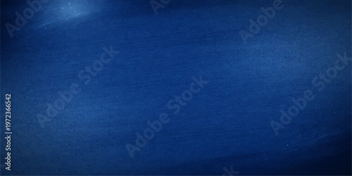 A dark blue denim fabric texture background features a rough cotton textile pattern with a vintage closeup surface design for a classic fashion clothing backdrop