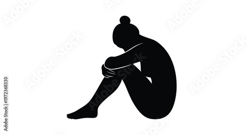 Abstract black silhouette of a person sitting curled up and hugging their knees in deep thought.