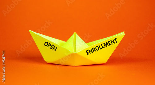 Open enrollment words symbol. Concept words Open enrollment on beautiful yellow paper boat. Beautiful orange background. Medical and Open enrollment words concept. Copy space.