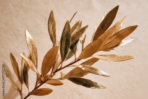Golden Olive Branch with Detailed Leaves Against a Soft Background.