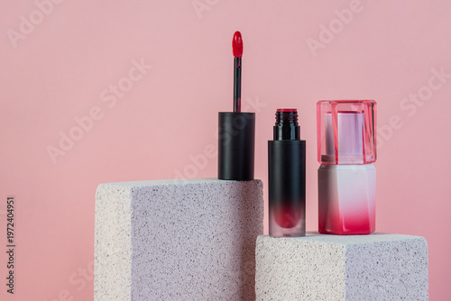 Mock up of black blank thin tube - mascara, lip gloss, gel, eyeliner, oil, etc. Cosmetic package with stylish props on pink background. 