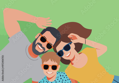 Family enjoys sunny day outdoors wearing sunglasses and having fun on green grass