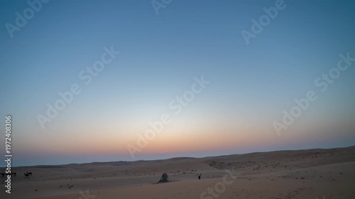 Beautiful sunset-sunrise time lapse with rotation over a desert sand dune. Vibrant sky transitions, golden light on sand dunes 