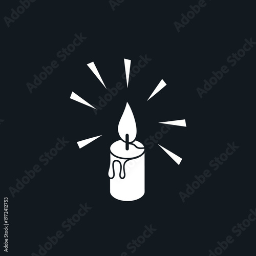 A white candle with a flame.