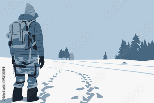 Hiker stands in snow with winter landscape and tree lines in the background during a cold day in a remote area