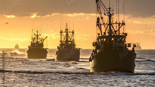 Fishing boats sail towards the viewer at sunset over the ocean