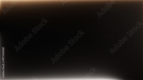 A close-up shot of a dark, gradient background with a smooth transition from deep brown to light beige tones.