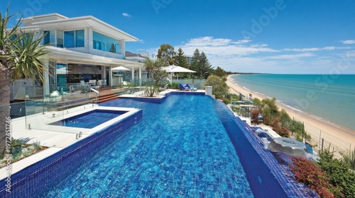 Luxury beachfront villa with infinity pool and ocean view on a sunny day