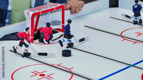 Photography Close up action shot of a tabletop hockey game being played