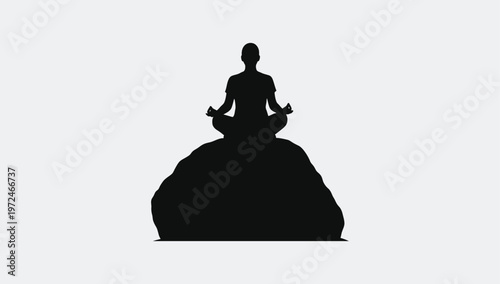 A silhouette of a person sitting in a meditative lotus pose atop a large rounded rock formation