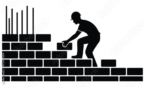 Silhouette of a construction worker building a brick wall with rebar in the background.