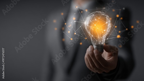 Businessman holding a glowing light bulb with network connections