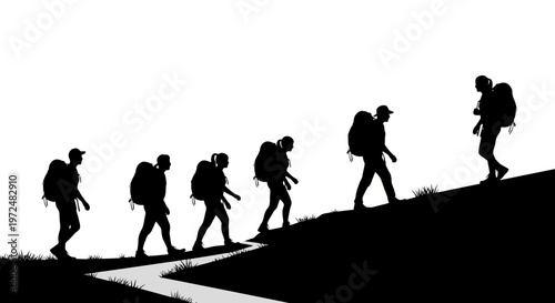 Silhouettes of hikers walking up a hill with backpacks.