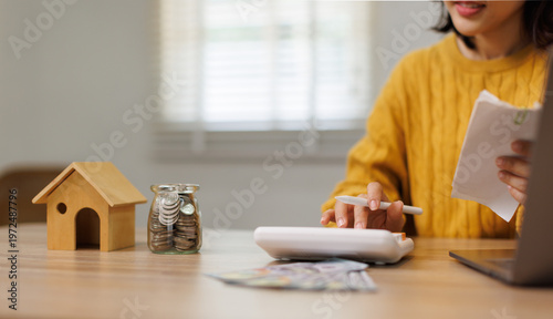 Quadro em tela Woman managing personal finances, calculating a budget for a new home,
