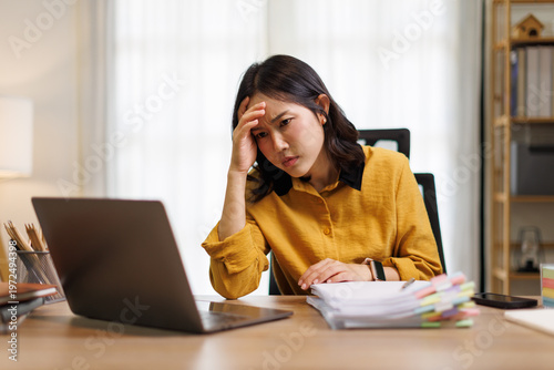 Fotografi Stressed young Asian woman experiencing a headache and burnout