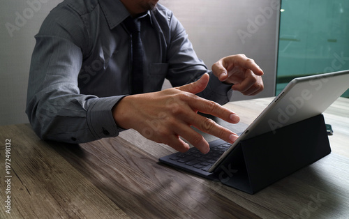 Businessman Using Tablet with Keyboard in Modern Office Workspace