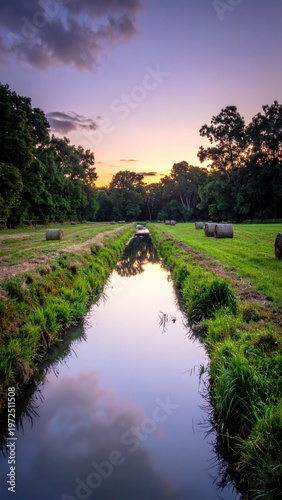 Peaceful Sunset Over Reflective Stream Surrounded by Lush Nature