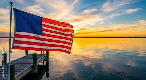 American flag waving at sunset over water a patriotic scene