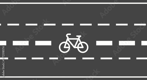 Bicycle lane symbol painted on asphalt road with white dashed lines, dedicated cycling path.