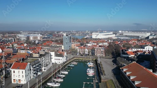 Vlissingen, Zeeland, the Netherlands. Aerial shot of little harbor with yachts and sailboats, pulling back to reveal old town with scenic houses. 