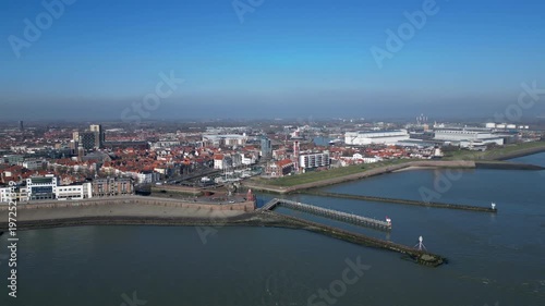 Vlissingen, Zeeland, the Netherlands, May 3, 2025. Aerial approach shot of the historic city with the sailboat wharf, tower and coastline. 