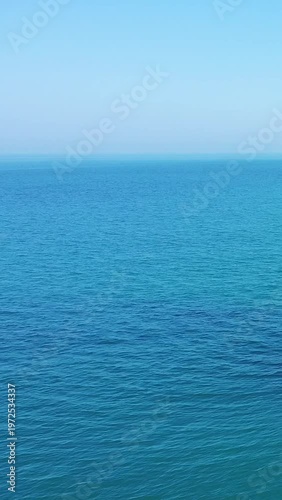 Tranquil view of the open blue sea under a clear sky, captured near the artificial port of Arromanches-les-Bains, Normandy, France.