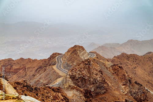Photos Aerial view of switchback mountain road with sharp hairpin bends steep rock formation